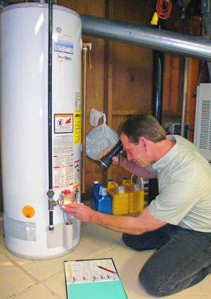 Plumber checking a water heater's intake valves